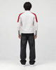 Model wearing the white and red moto jacket, back view