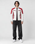 Model wearing the white and red moto jacket over a black tee, front view