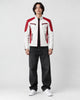 Model wearing the white and red moto jacket over a black tee, front view