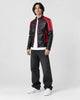 Model wearing the black and red PU leather moto jacket, three-quarter view