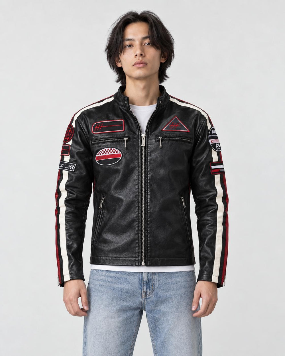 Model wearing the black racing patch moto jacket over a white tee, front view