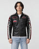 Model wearing the black racing patch moto jacket over a white tee, front view