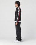 Model wearing the black racing patch moto jacket, side view of the sleeve stripes