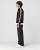 Model wearing the black racing patch moto jacket, side view of the sleeve stripes