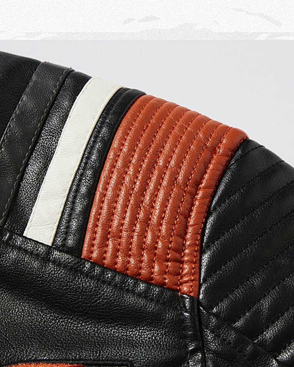 Close-up of the quilted orange and white shoulder stripes