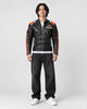 Model wearing the black racing stripe moto jacket over a white tee, front view