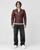 Model wearing the burgundy PU leather moto jacket, front view