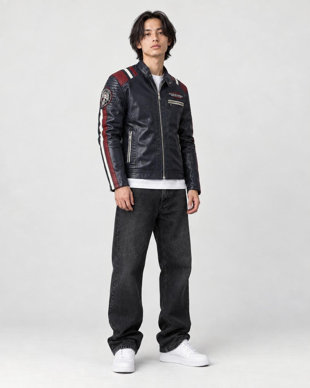 Model wearing the navy racing stripe moto jacket, three-quarter view