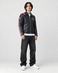 Model wearing the navy racing stripe moto jacket, three-quarter view