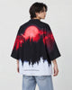 Man in the haori seen from behind at an angle, a red moon over black pines fading to white at the hem, over a white tee