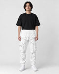 Model wearing white cargo joggers with gray-silver tape lines and a black tee, front view