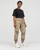 Model wearing khaki cargo joggers with reflective tape lines and a black tee, three-quarter view