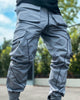 Blue gray cargo joggers with thin dark tape lines and large flap pockets