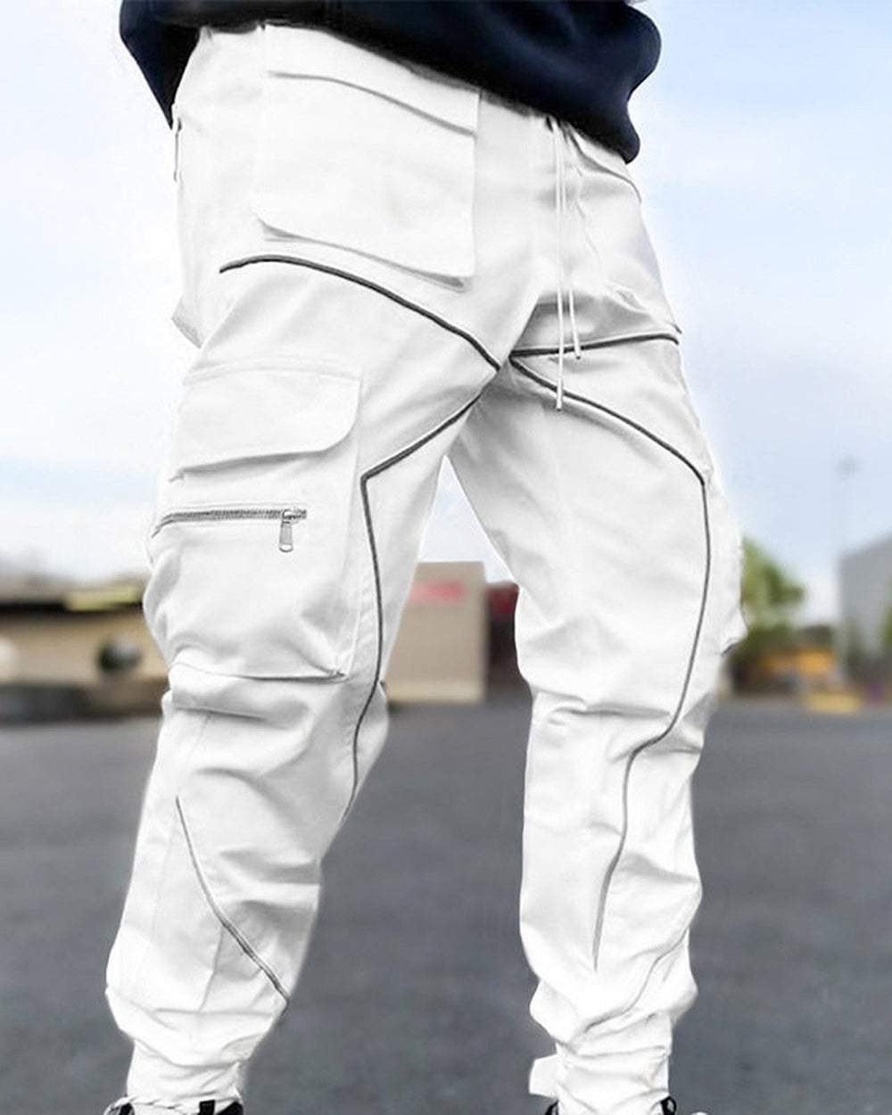 White cargo joggers with gray tape lines and large flap pockets