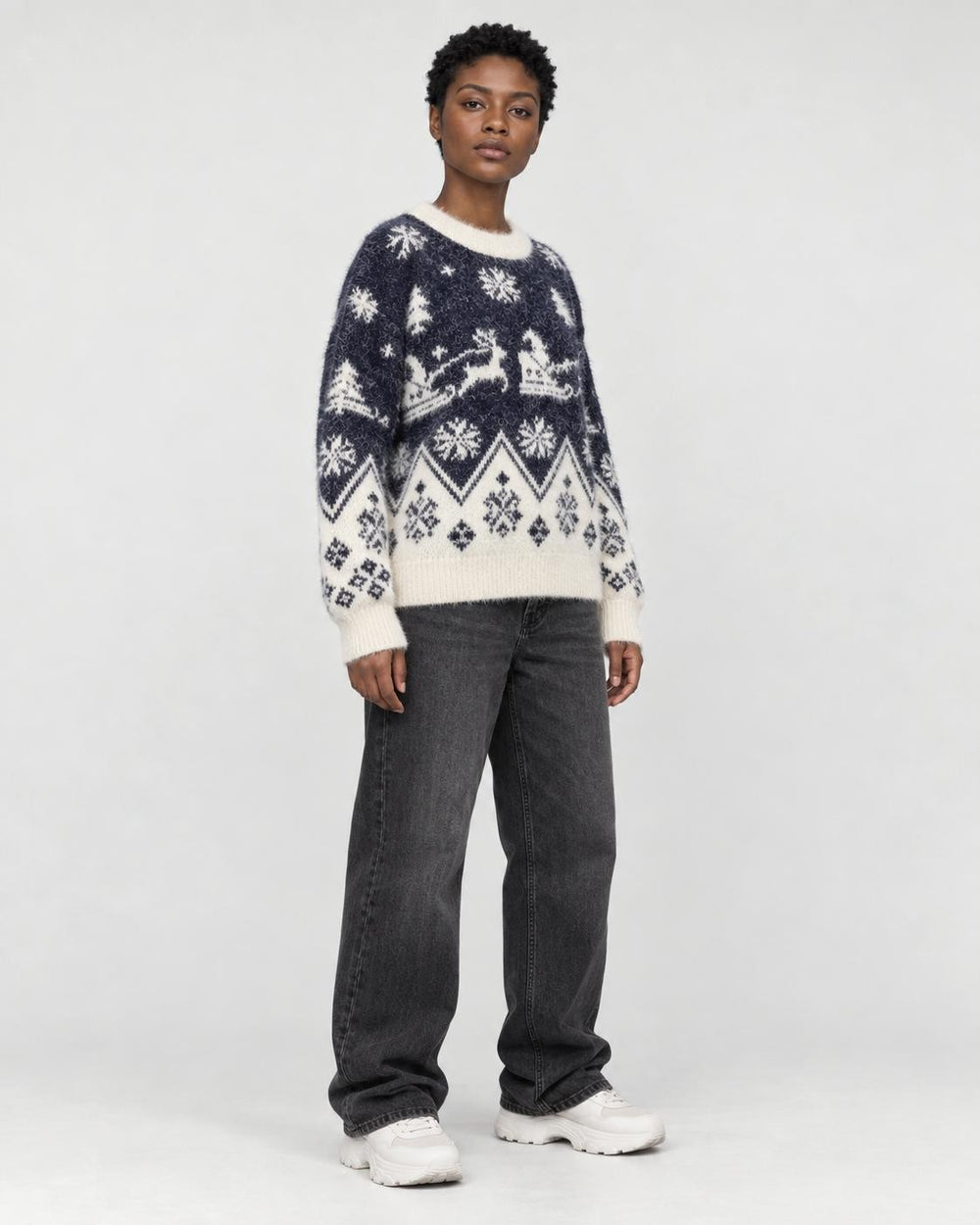 Model wearing the navy reindeer Christmas sweater, three-quarter view