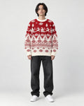 Model wearing the red reindeer Christmas sweater with jeans, front view