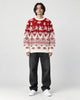 Model wearing the red reindeer Christmas sweater with jeans, front view