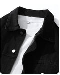 Close-up of the black denim collar, chest pocket edge and metal buttons