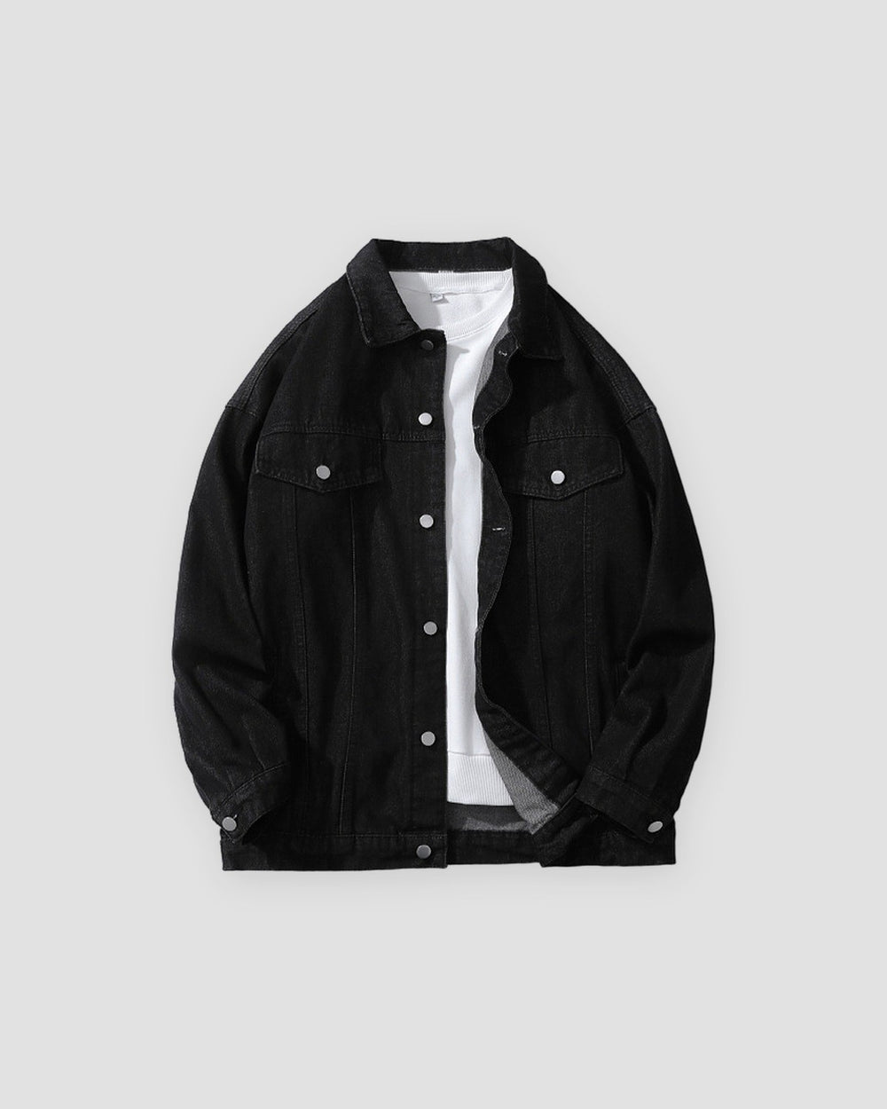 Black relaxed denim trucker jacket, front view, open over a white tee