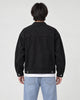 Model wearing the black denim trucker jacket, back view
