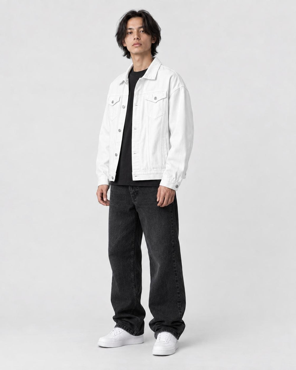 Model wearing the white denim trucker jacket, three-quarter view