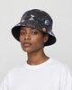 Model wearing the black astronaut and star chart bucket hat with a white tee, side view