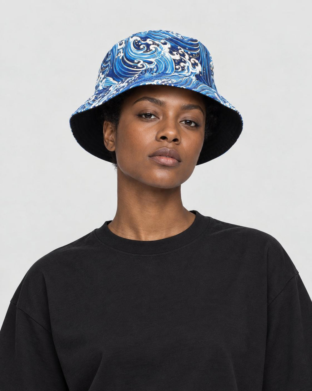 Model wearing the blue great wave print bucket hat with a black tee, side view
