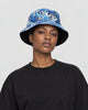 Model wearing the blue great wave print bucket hat with a black tee, side view