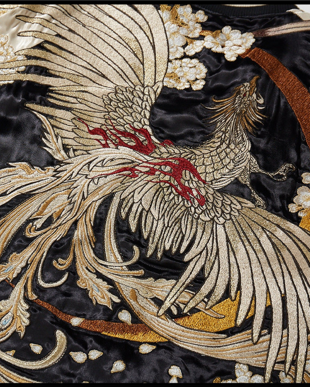 Close view of the phoenix embroidery in silver, cream and gold thread with red accents on glossy black fabric