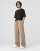 Model wearing khaki ribbed corduroy wide-leg pants with a black tee and white sneakers, three-quarter view
