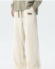 Cream ribbed corduroy wide-leg pants worn with an olive sweatshirt