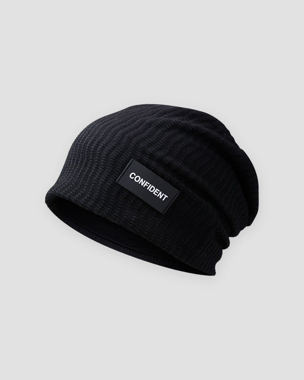 Black ribbed slouchy beanie with a small black label reading CONFIDENT