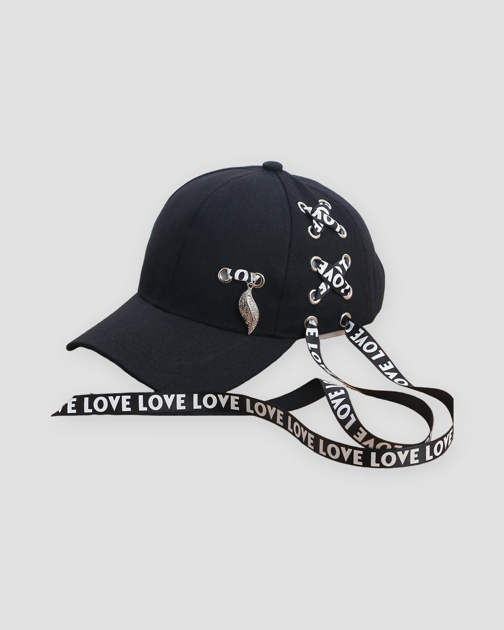 Black baseball cap laced with LOVE ribbon and a silver leaf pendant, three-quarter view