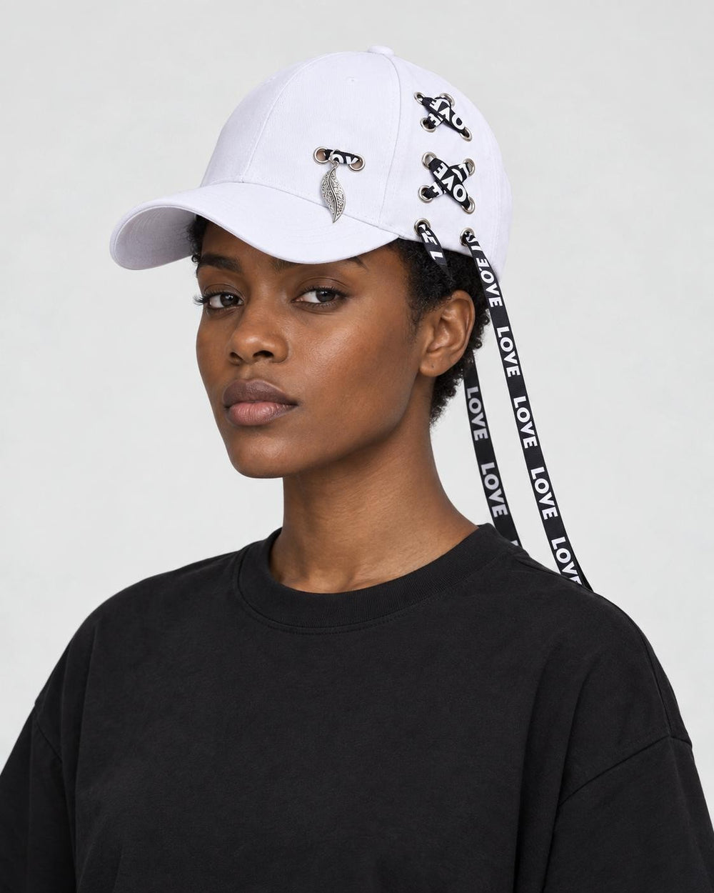 Model wearing the white ribbon-laced cap with a black tee, side view