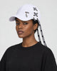 Model wearing the white ribbon-laced cap with a black tee, side view