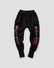 Black cargo joggers with red camo pocket linings and printed ribbon straps, flat view
