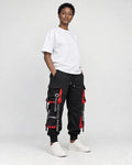 Model wearing the black ribbon strap cargo joggers with a white tee, three-quarter view
