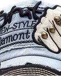 Close-up of the embroidered fist patch and metal rivets
