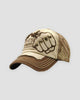 Beige and brown distressed cap with a riveted embroidered fist patch