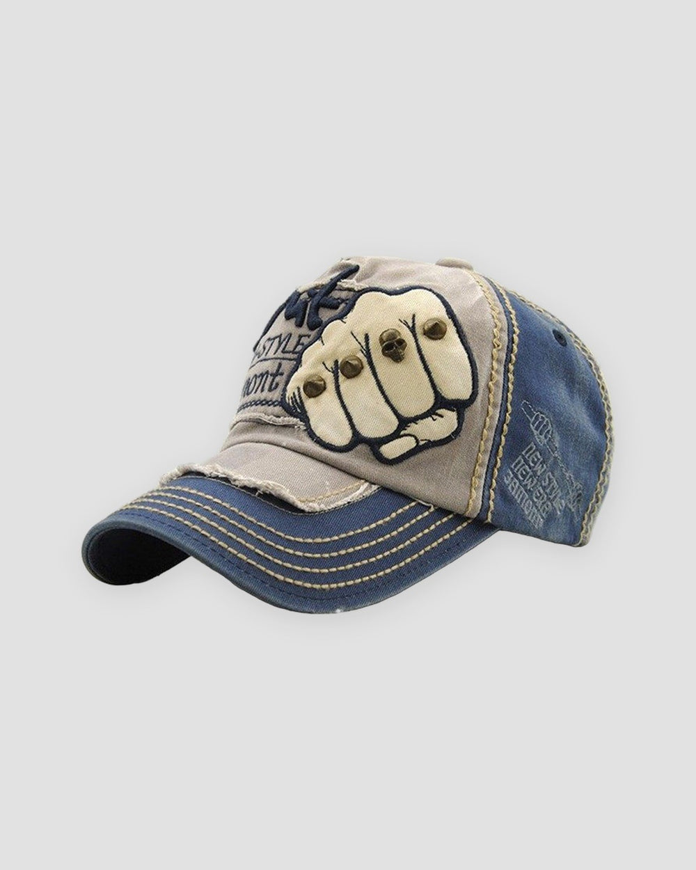 Gray and navy distressed cap with a riveted fist patch