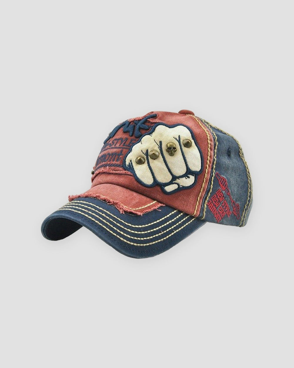 Red and navy distressed cap with a riveted fist patch