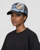 Model wearing the light blue and black fist patch cap, three-quarter view