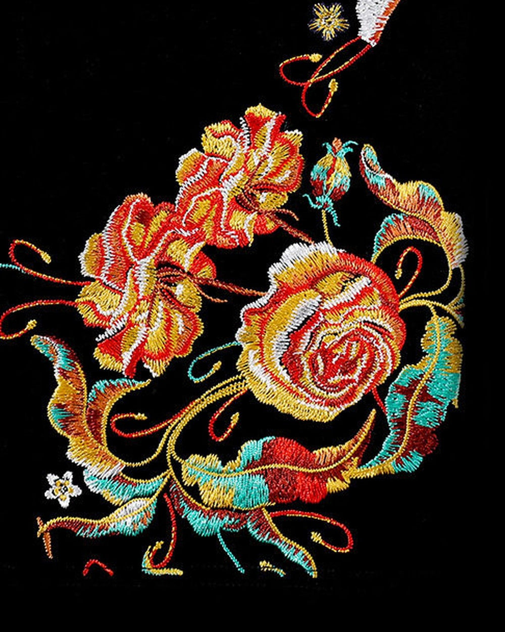 Close-up of the orange-red and gold roses embroidered along the hem of the black tee