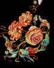 Close-up of the orange-red and gold roses embroidered along the hem of the black tee