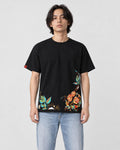 Model wearing the black rose hem embroidered tee with light-wash jeans, front view