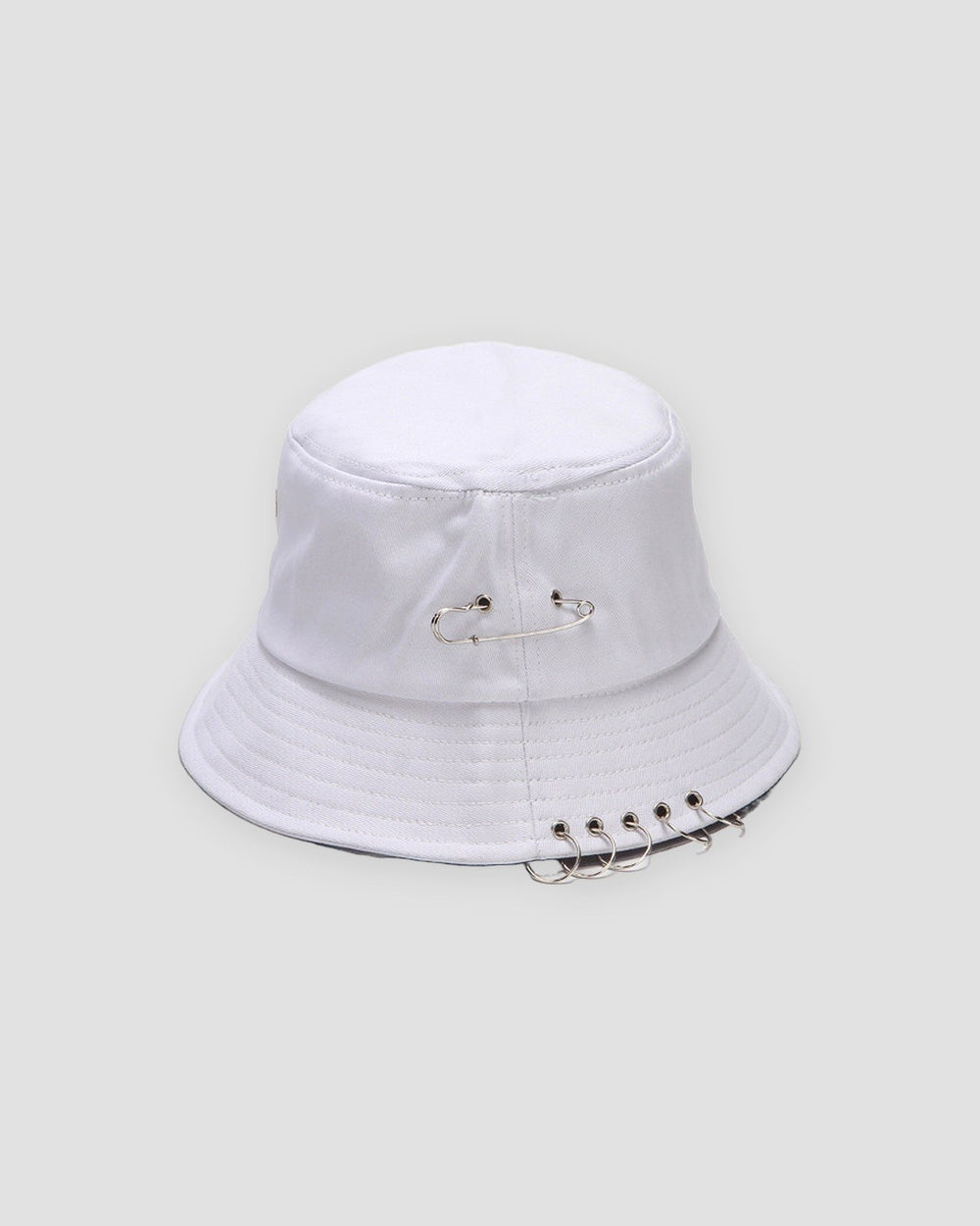 White safety pin bucket hat with five metal rings through the brim