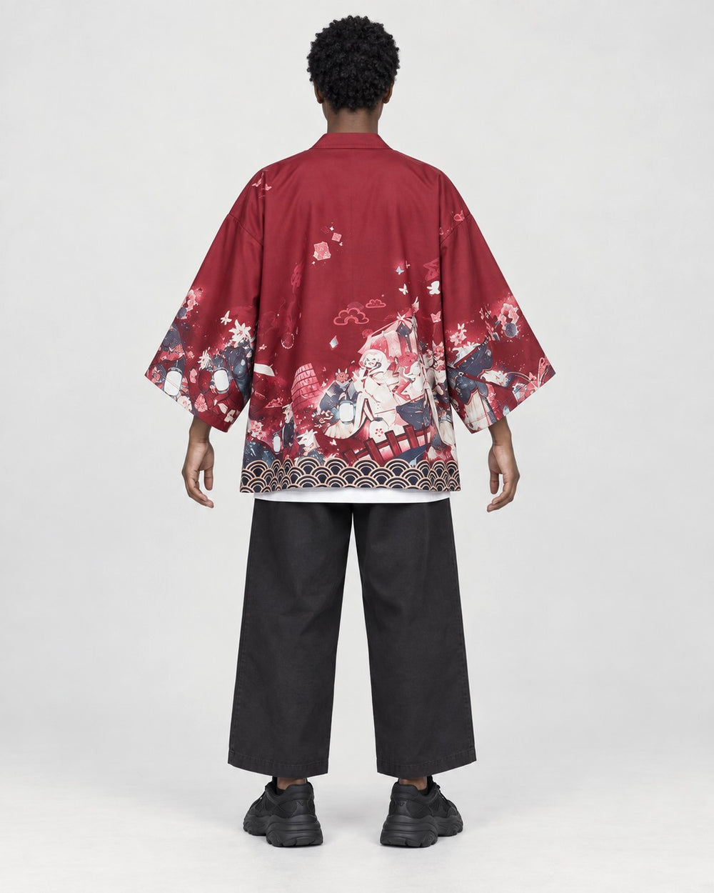 Model wearing the sakura print kimono jacket, back view, cherry blossom scene above a patterned hem