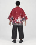 Model wearing the sakura print kimono jacket, back view, cherry blossom scene above a patterned hem
