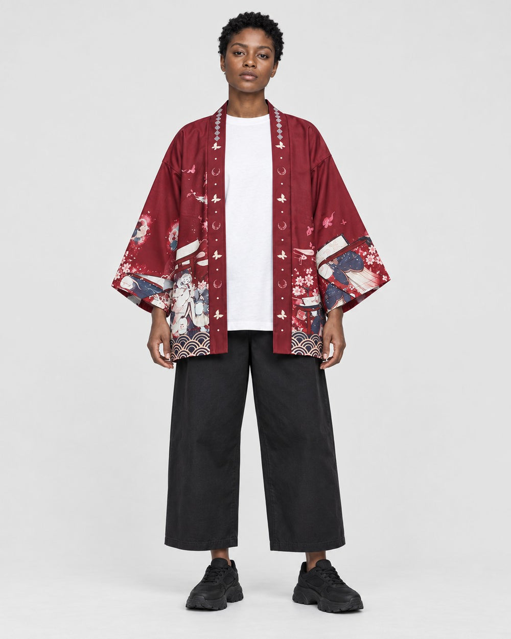 Model wearing the sakura print kimono jacket open, red side out, front view
