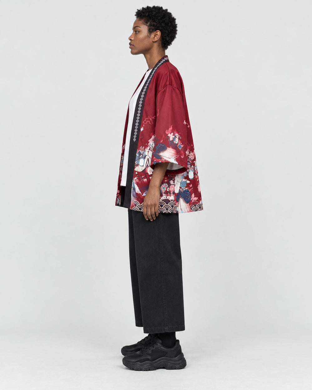 Model wearing the sakura print kimono jacket, red side out, side view